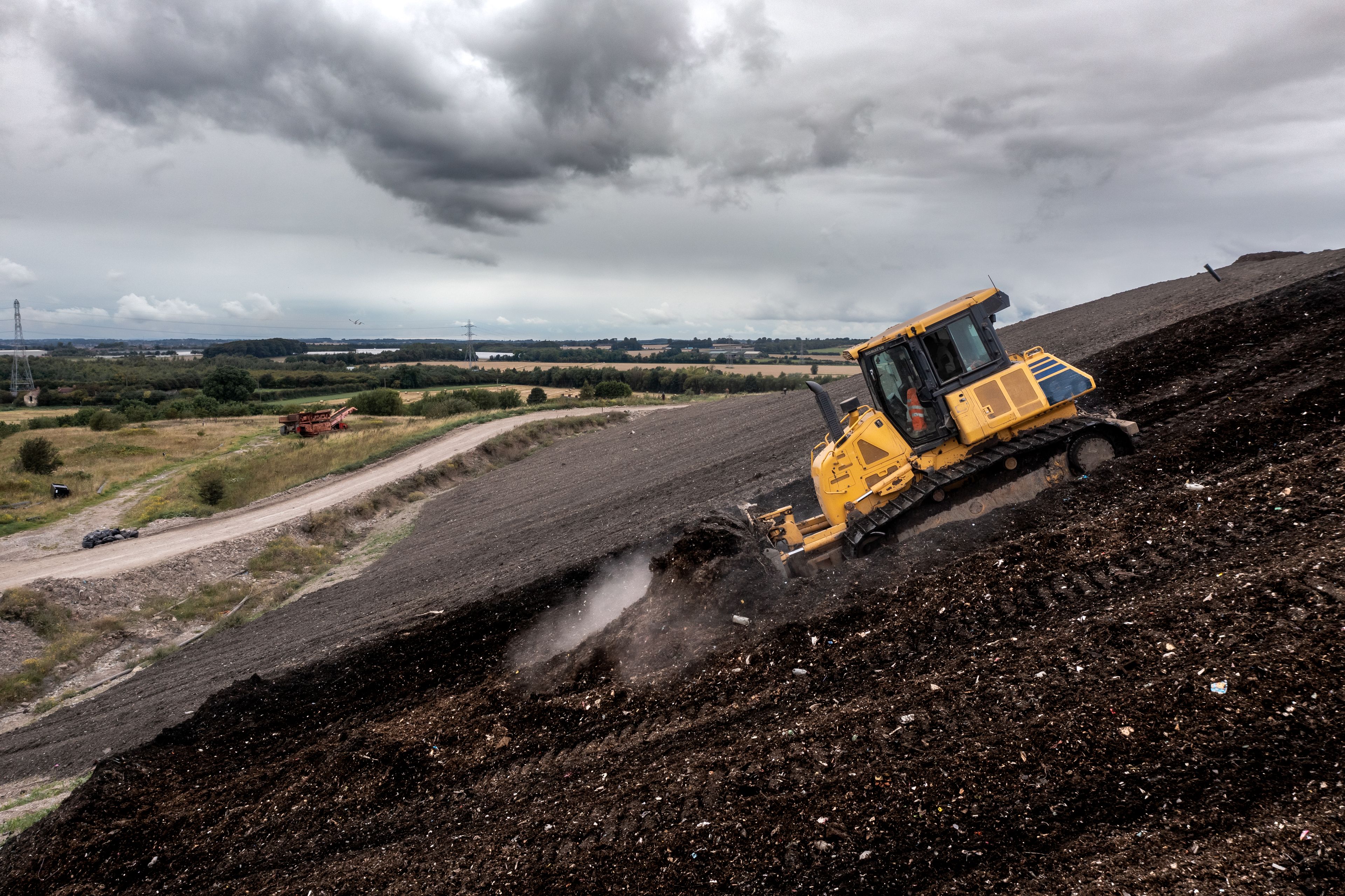 a bulldozer is driving down a dirt hill 