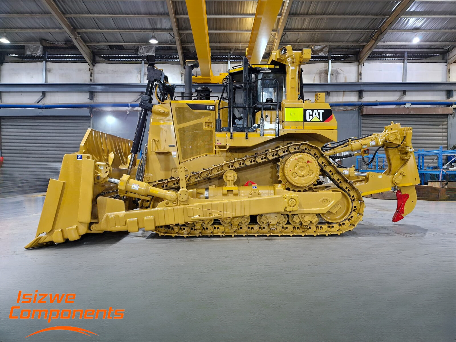 a large yellow cat bulldozer sits in a warehouse